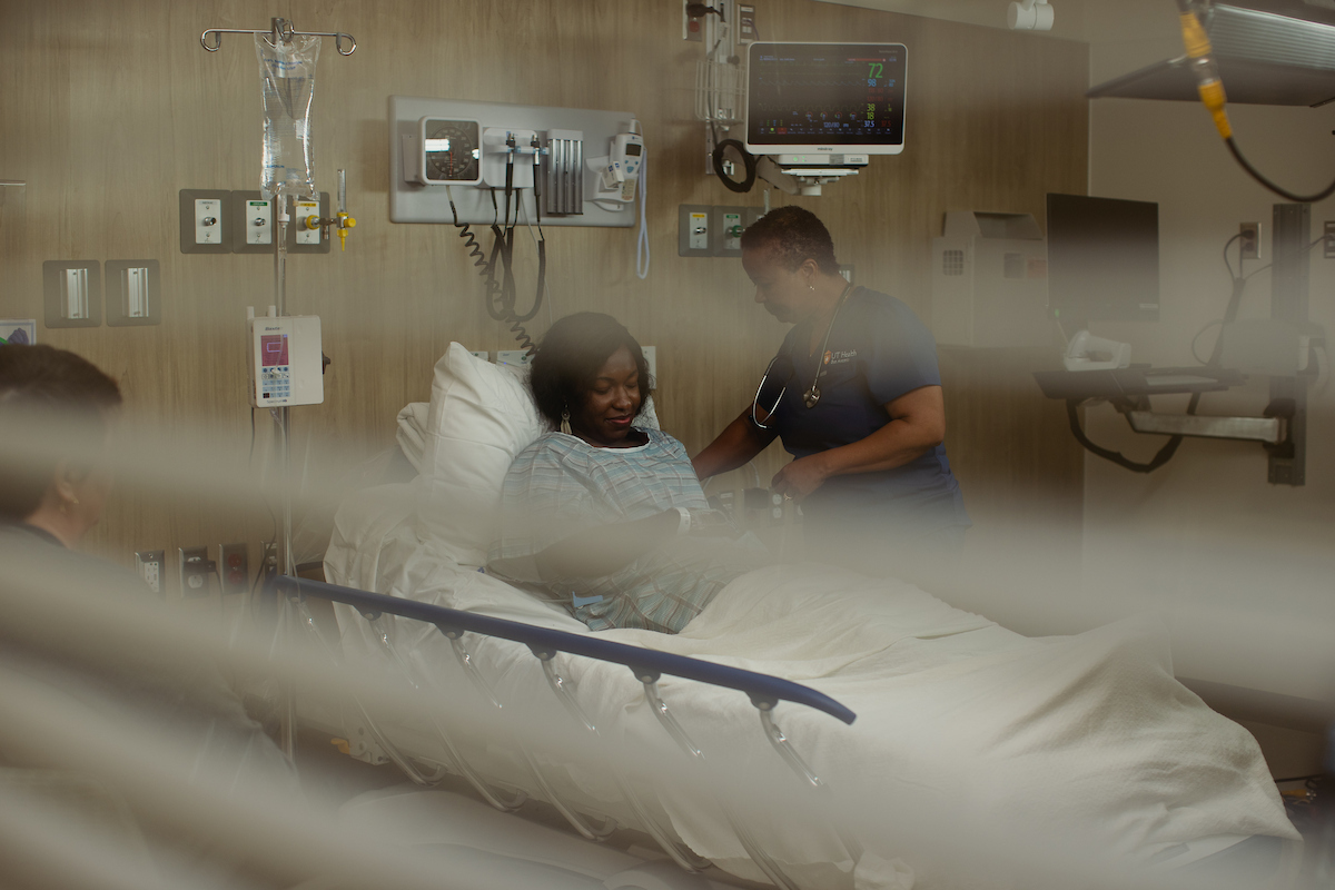 Patient recovering from surgery at Texas hospital with nurse and visitor
