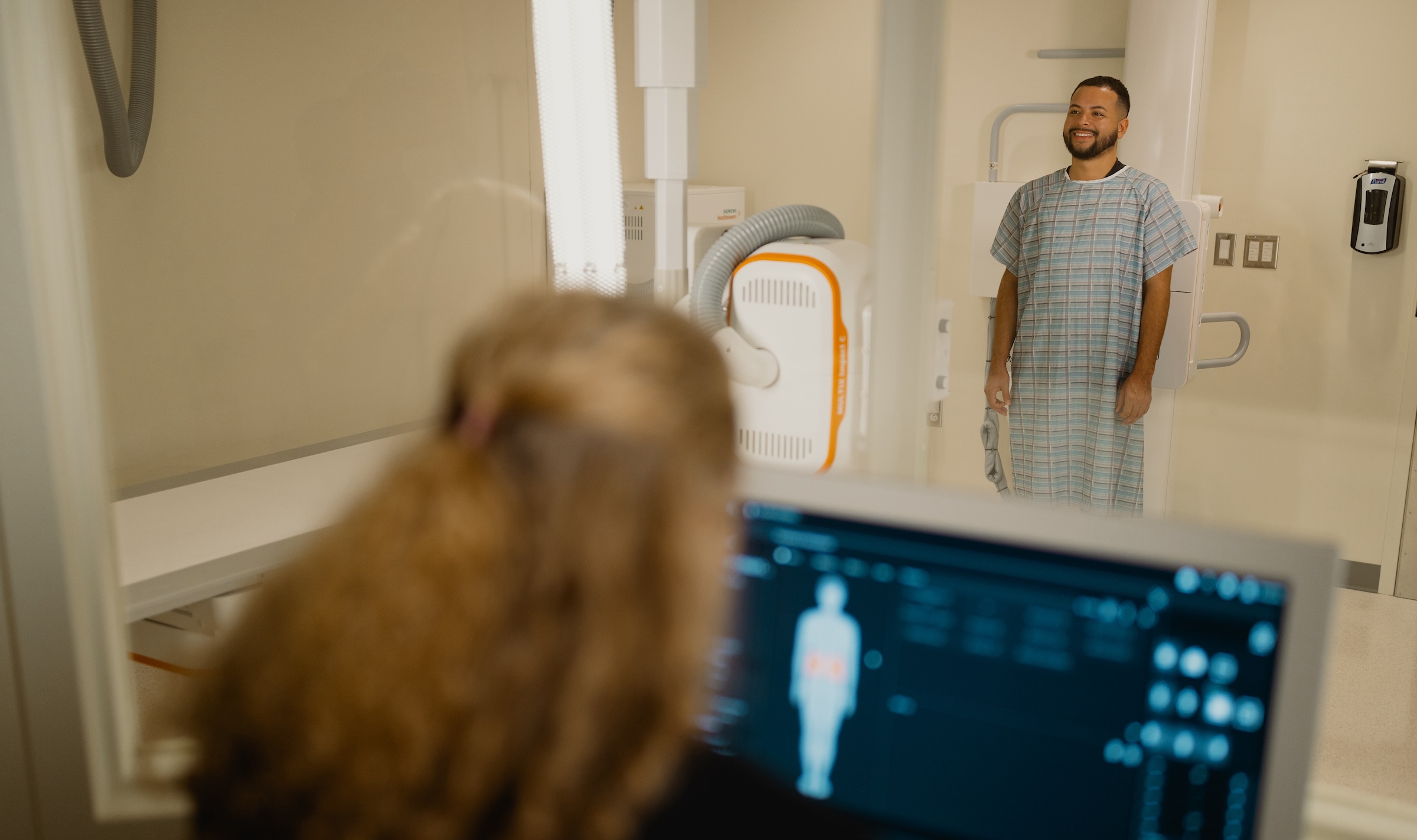 Imaging tech sets up a patient for xray