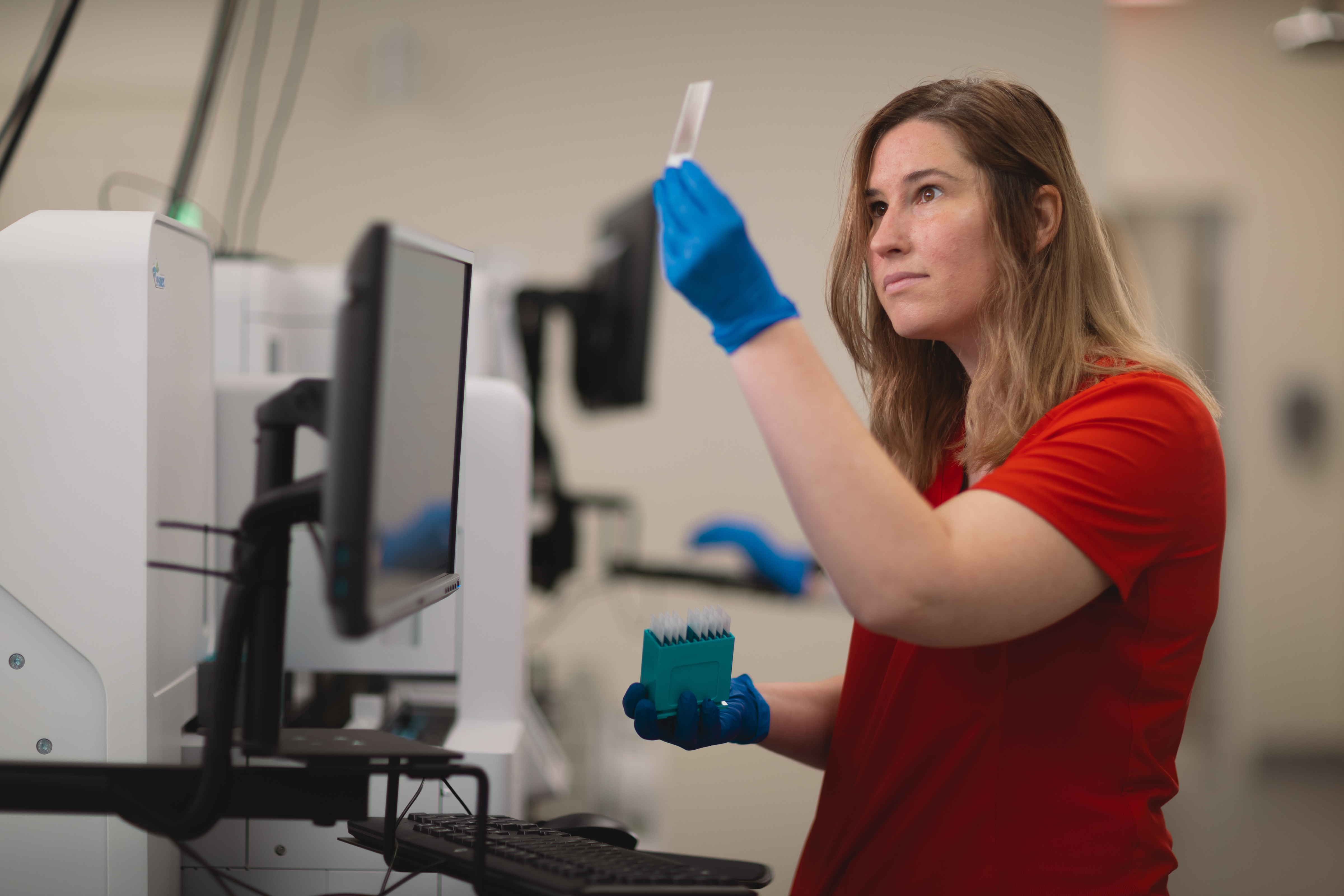 Lab tech analyzes a smear